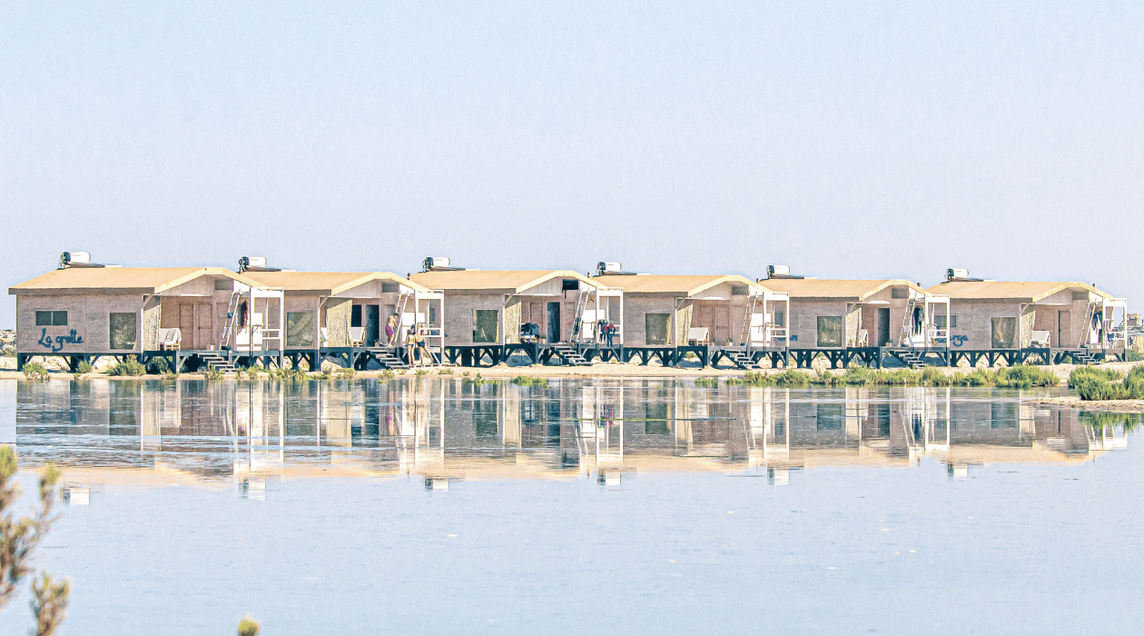 ecolodge en fond avec leurs reflet dans l'eau